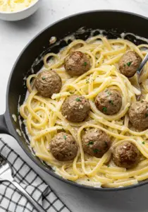 Garlic Butter Meatballs over Creamy Parmesan Linguine
